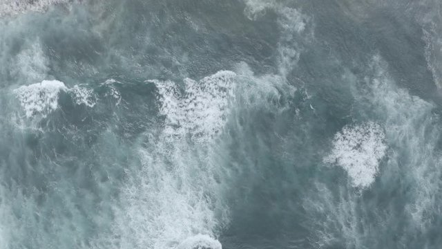 Aerial view to ocean waves. Blue water background. Photo made from above by drone. DJI Mavic 2 Pro 4k dlog-m ungraded flat.