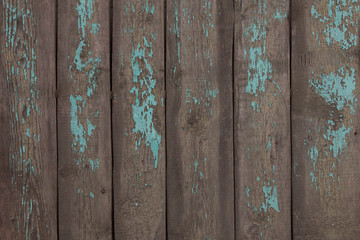 Background, texture of an old, wooden fence with remains of paint.