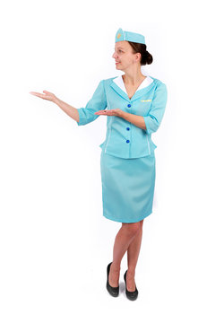 Stewardesse - Charming and smiling Stewardess Dressed In Blue Uniform Holding In Hand. Isolated on white background