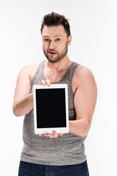 Overweight Man Looking At Camera And Showing Digital Tablet With Blank Screen Isolated On White