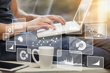 Hands typing on keyboard of modern laptop