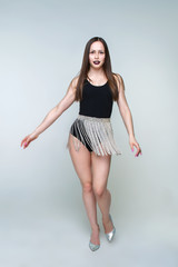 Naklejka premium Beautiful and young girl in tight clothes for dancing. A girl with long hair.