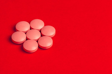 Top view of pharmaceutical medicine pills on red background