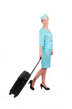 Stewardesse - Charming and smiling Stewardess Dressed In Blue Uniform And Suitcase . Isolated on white background