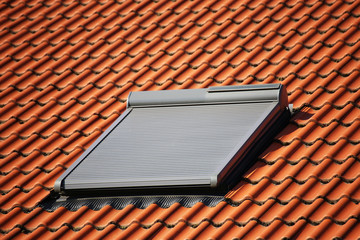 Roof window with roller shutter