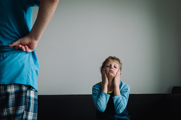 angry parent looking at tired, ashamed and exhausted kid