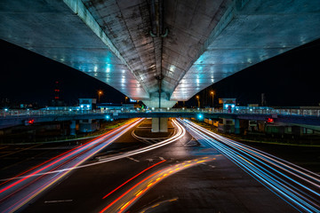 Fototapeta na wymiar 夜の交通道路の様子, A Traffic Road with Many Shining Car Lights at Night