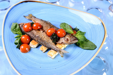 fried fish with vegetables and basil