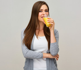 smiling woman holding orange juice drink.