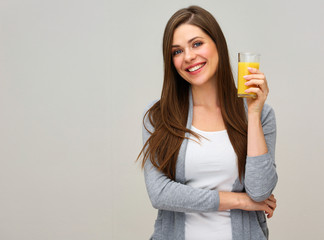 smiling woman holding orange juice drink.