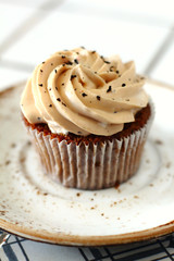 Chocolate homemade cupcakes with earl gray tea buttercream frosting on white plate. Dessert bakery style food photo 