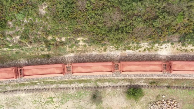 Freight train aerial drone view over wagons with shipment on a railway 