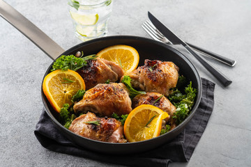 Chicken thighs with orange is a pan.