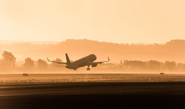 Passenger airplane on the evening, sunset background.