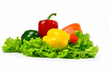 Fresh washed sweet pepper lies on lettuce leaves.