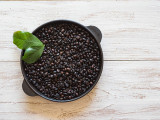 Grains of roasted coffee in a pan. 