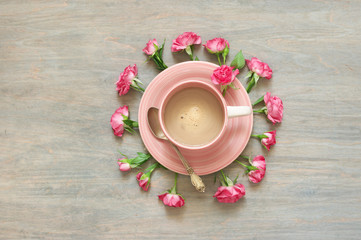 Cup of creamy coffee with flowers decor