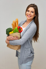 woman holding paper bag with shopping from the grocery store