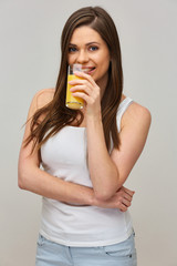 smiling woman drinking orange juice.