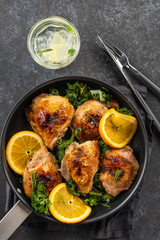 Pieces of chicken baked with oranges and red pepper.