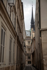 Fototapeta na wymiar Spire of Notre Dame de Paris Cathedral before fire. Old narrow street in Paris, France, Europe