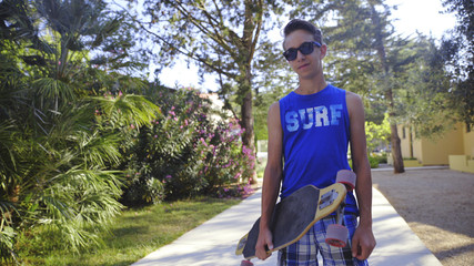 Cool guy with a longboard and sunglasses