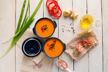 Tomato soup with chicken p with bacon. Garlic, onion. Oil. Ingredients. Kitchen. Wooden white table. 