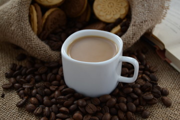 A cup of coffee. While reading a book, have a cup of coffee with cookies. Stop for a minute, coffee is a pleasure.