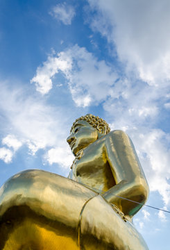 Gold color Statue in thai temple over blue sky