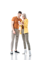 smiling young man and woman looking at smartphone together isolated on white