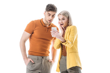 surprised young man and woman looking at smartphone isolated on white