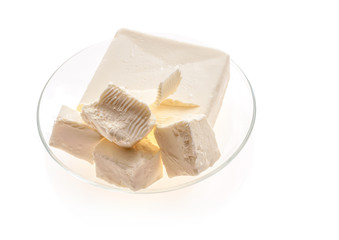 Butter pieces in plate isolated on white background