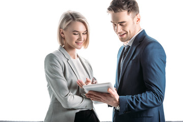 smiling young business partners using digital tablet isolated in white