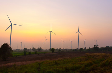 Fototapeta na wymiar A Wind Turbine on a Wind Farm at sunrise time.