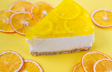 Fototapeta na wymiar piece of lemon cheesecake on yellow background