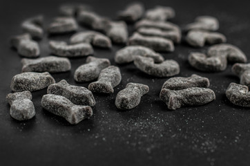 licorice candy fish on black background