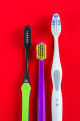 multicolored toothbrushes on a red background