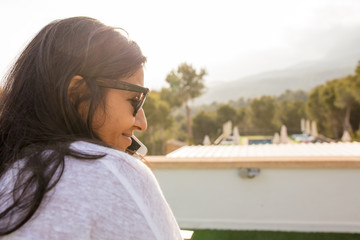 Fototapeta na wymiar young Indian woman talking on mobile phone