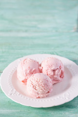 strawberry ice cream on a turquoise surface