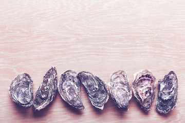 Closed oysters on wooden background. Healthy sea food