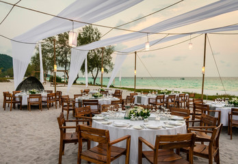 romantic wedding table design at sunset outside on asian beach