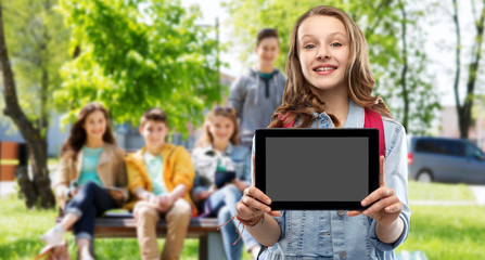 education, school and people concept - happy smiling teenage student girl with bag showing blank tablet computer screen over group of friends outdoors background