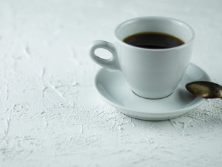 A cup of coffee on a light stone background