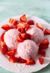 strawberry ice cream on a turquoise surface
