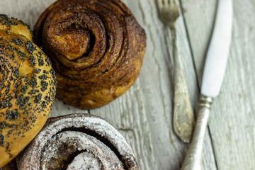 sweet buns on a rough wooden background