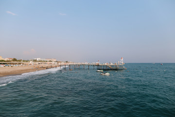 A pontoon on the mediterranean sea at sunset. Sea horizon and sunset sky. Vacation concept.