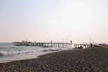 A pontoon on the mediterranean sea at sunset. Sea horizon and sunset sky. Vacation concept.