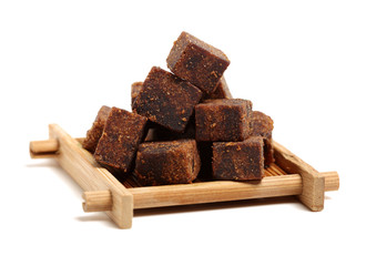 brown cubes of sugar on white background
