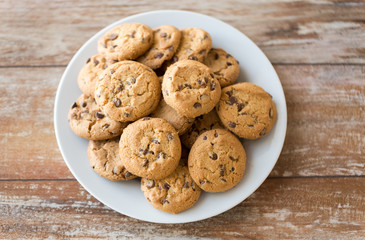 food, junk-food and eating concept - close up of oatmeal cookies with chocolate chips on plate