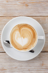 coffee art cup on wooden background top view